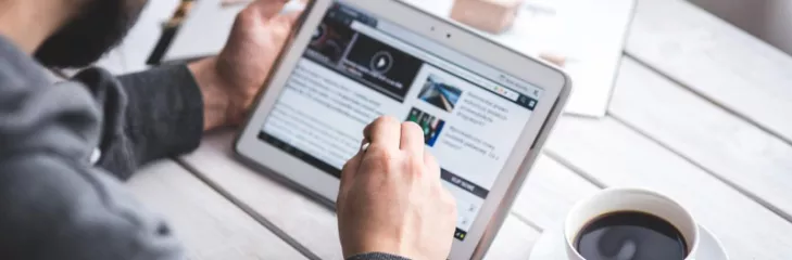 man browsing an article on a tablet
