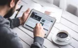 man browsing an article on a tablet
